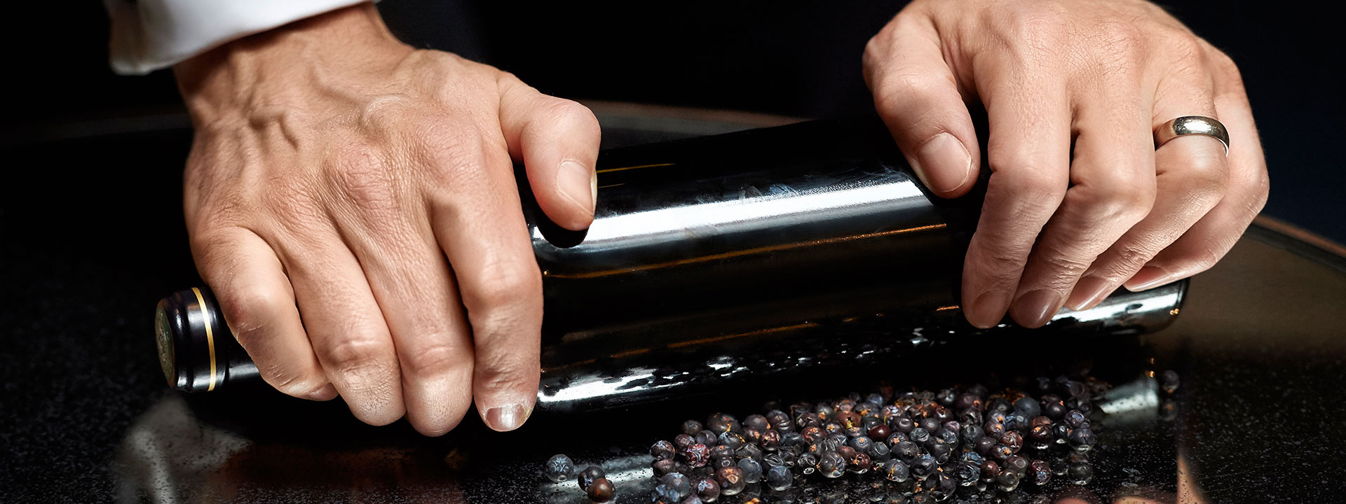 Mixologist rolling small black berries at The Connaught Bar in Mayfair